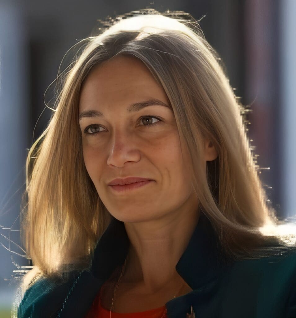 Woman smiling with long blonde hair.