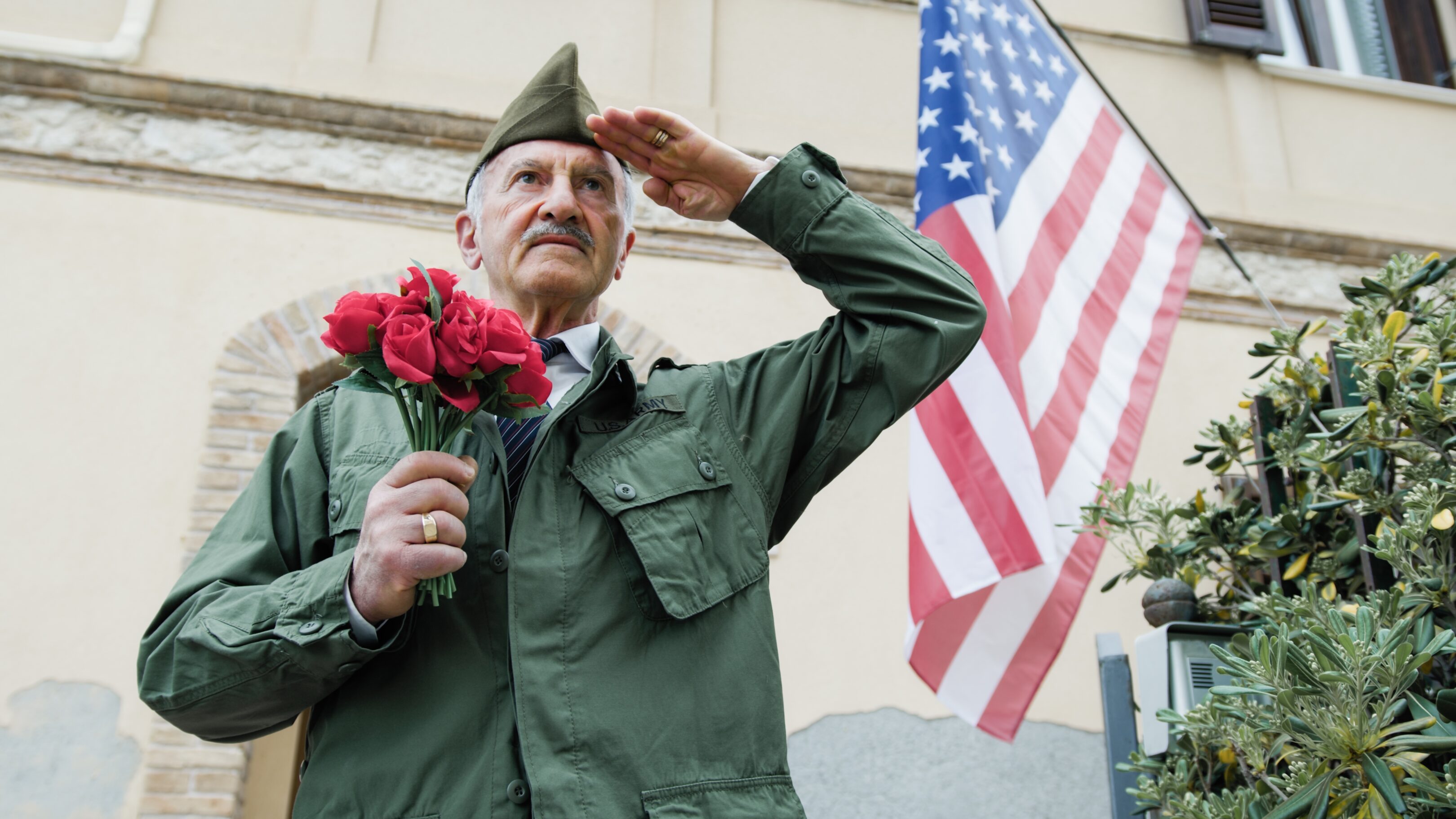 Elderly,Veteran,Man,Salutes,In,Front,Of,The,American,Flag
