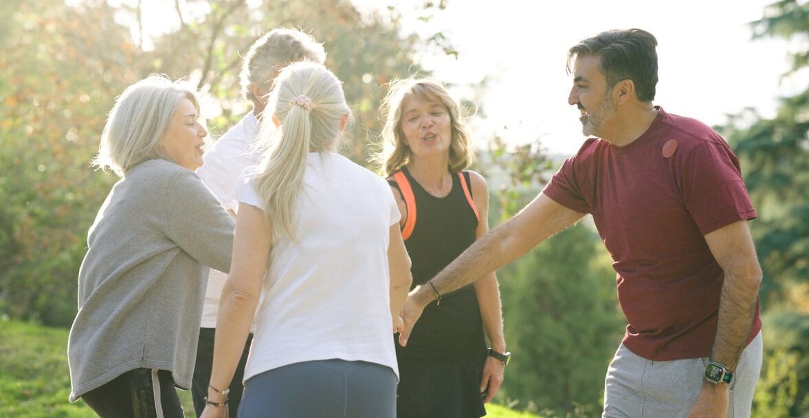 Group of people exercising outdoors together.