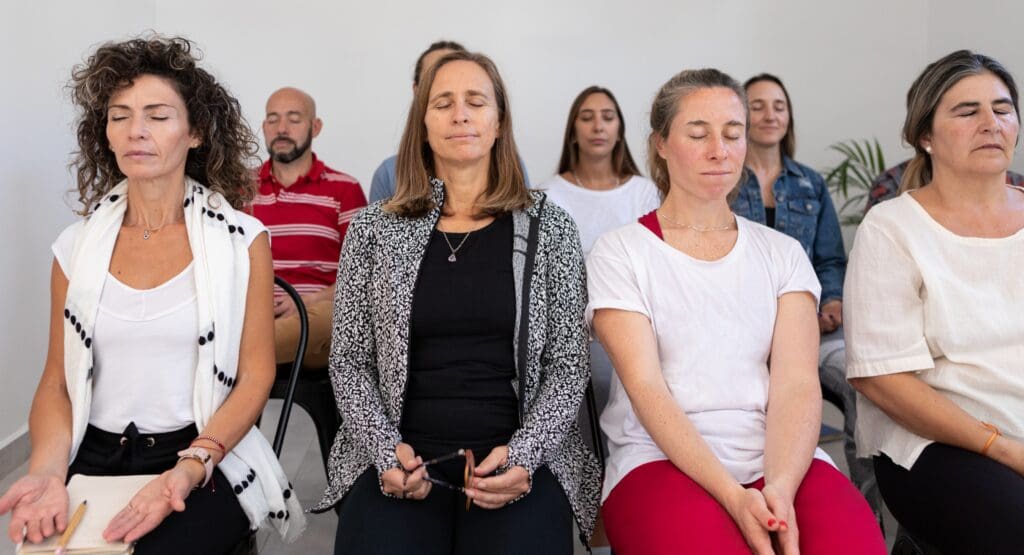 A group of adults meditating.