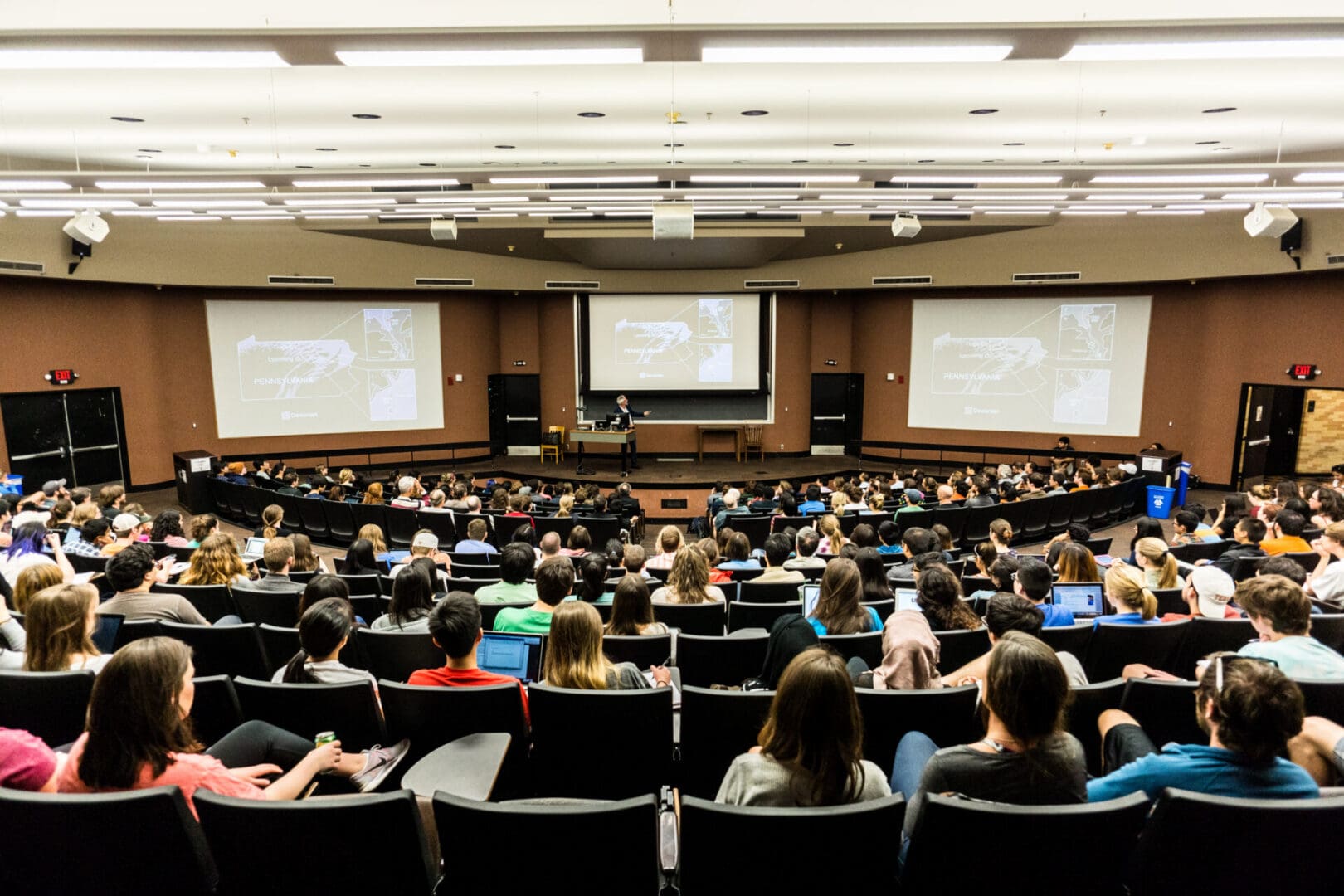 Large lecture hall filled with students and professor