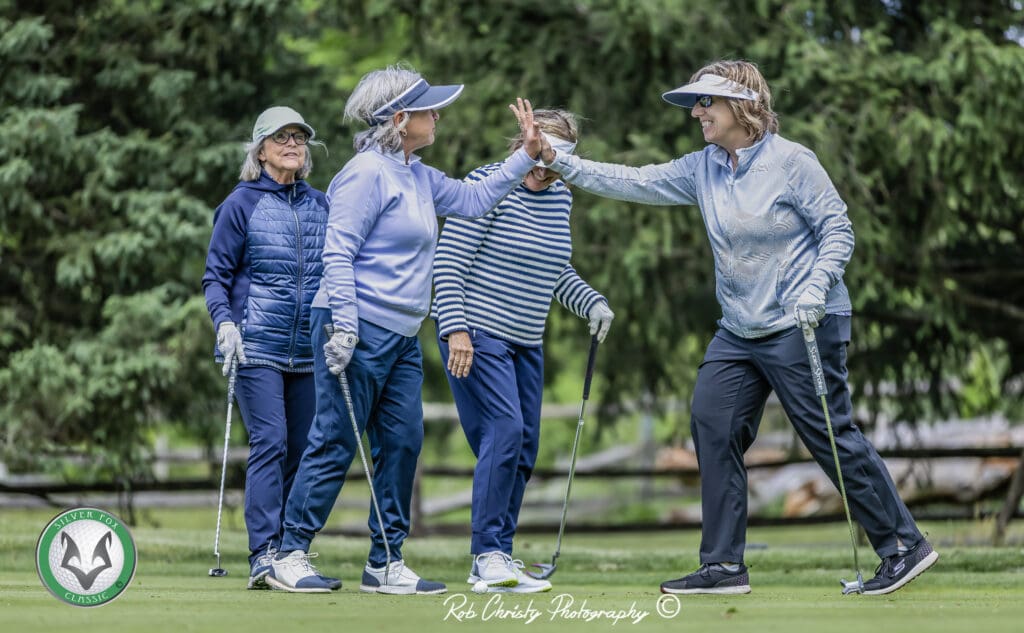 A team celebrates after a successful putt.