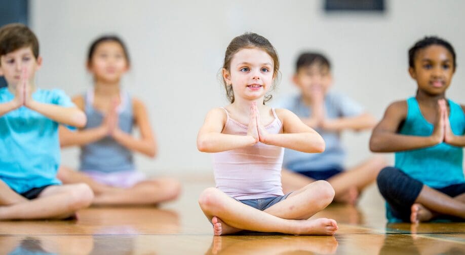 A group of children practicing yoga