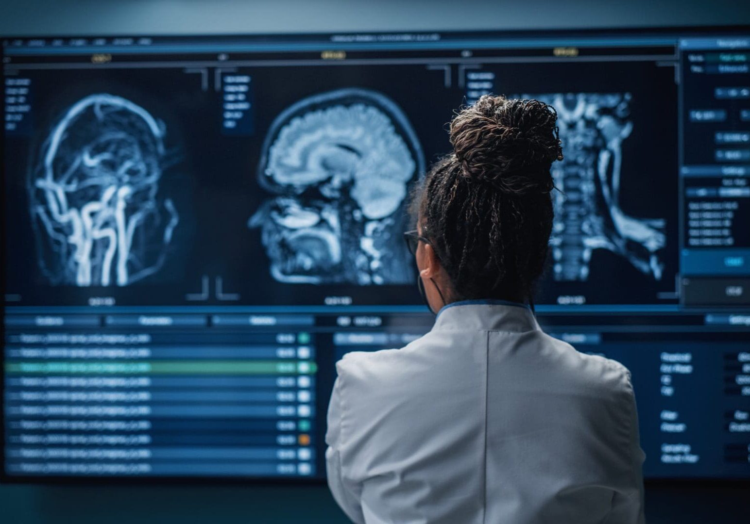 researcher looking at brain scans