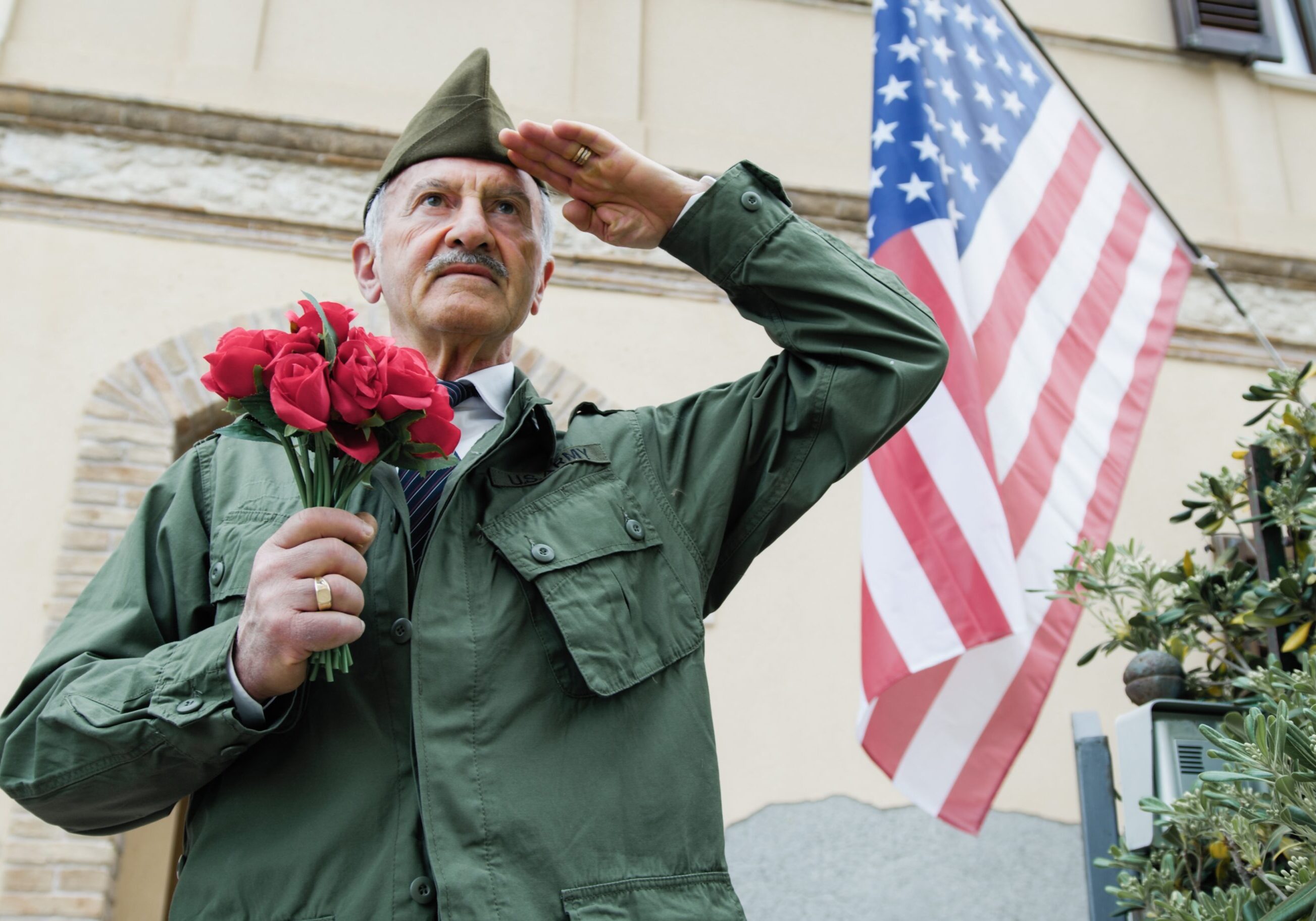 Elderly,Veteran,Man,Salutes,In,Front,Of,The,American,Flag